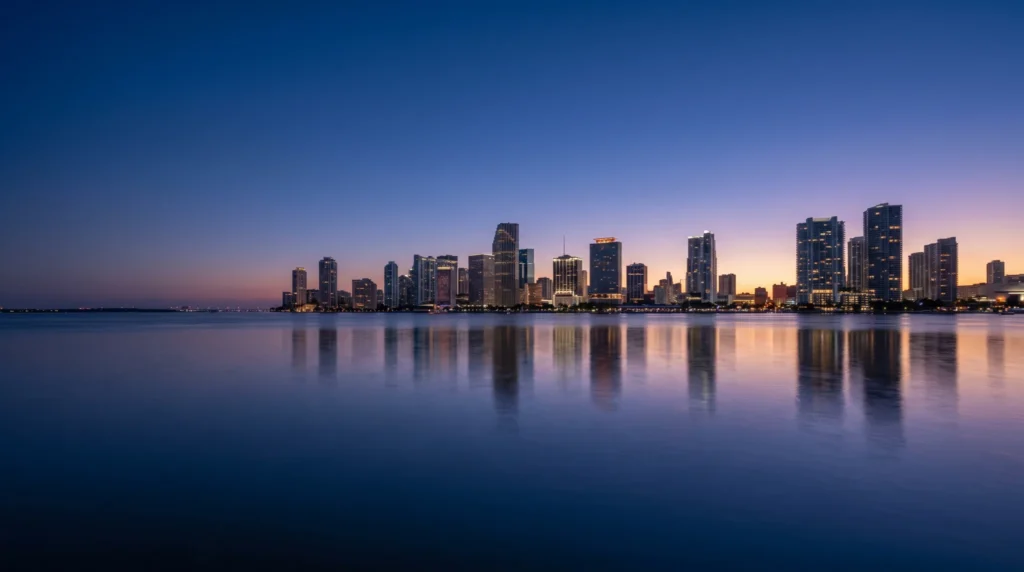 The Miami skyline at blue hour reflected in calm water